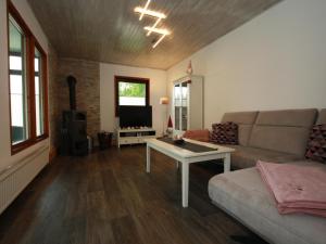 a living room with a couch and a table at Ferienhaus in Clausthal-Zellerfeld mit Terrasse in Clausthal-Zellerfeld +70 photos