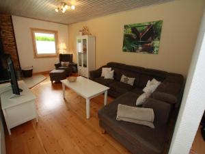 a living room with a couch and a table at Ferienhaus in Clausthal-Zellerfeld mit Terrasse in Clausthal-Zellerfeld