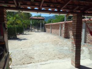 an open gate to a yard with a playground at Finca vacacional la manuelita in Girardot