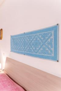 a close up of a headboard of a bed at Bene Ennidhos House - Alghero centro storico in Alghero