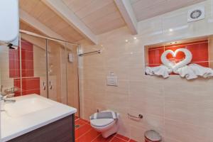 a bathroom with a toilet a sink and a shower at Imperial Studios in Vasiliki +55 photos