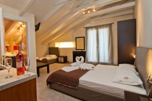 a bedroom with a large bed with towels on it at Imperial Studios in Vasiliki