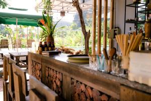 a counter in a restaurant with a table and chairs at The Hive Homestay - Tam Coc in Ninh Binh
