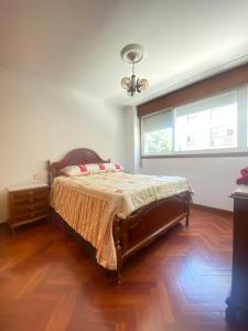 a bedroom with a large bed and a window at Apartamento Ponte Stay 33 in Ponteareas