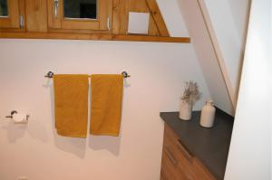 a bathroom with two towels hanging on a wall at Ferienhaus Eulennest in Billerbeck