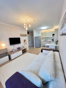 a living room with a large bed and a kitchen at Entire place, City center, Downtown, 1Bedroom apartment, Serviced, with amenities in Ulaanbaatar