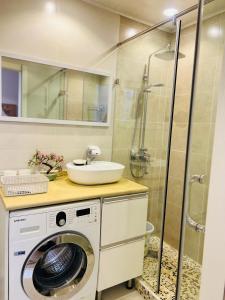 a bathroom with a washing machine and a sink at Entire place, City center, Downtown, 1Bedroom apartment, Serviced, with amenities in Ulaanbaatar