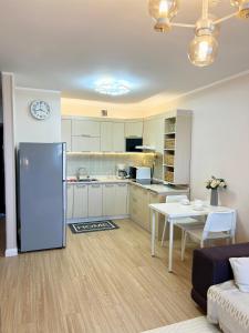 a kitchen with a refrigerator and a table in a room at Entire place, City center, Downtown, 1Bedroom apartment, Serviced, with amenities in Ulaanbaatar