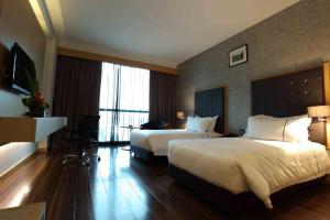 Katil atau katil-katil dalam bilik di Symphony Suites Hotel