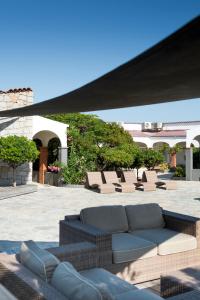 un grupo de sofás sentados en un patio en Le Lido en Propriano