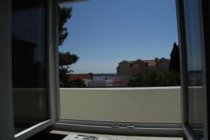 an open window with a view of a city at Bed & Breakfast Novalja Inn in Novalja