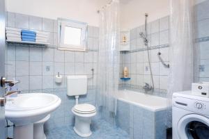 a bathroom with a toilet and a sink and a tub at Holiday Home Iris in Marina +19 photos