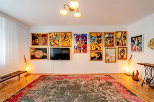 a living room with paintings on the wall at Central Art Apartment with Treasure Hunt, Free Parking & Self Check-In in Constanţa +52 photos