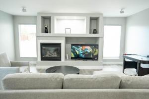 a living room with a couch and a table at 3240 Sqft Family-Friendly Retreat l Salt Lake Area in West Jordan