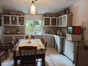 a kitchen with a table and chairs and a microwave at Michelles at Peradeniya Kandy in Kiribatkumbura