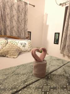 a bedroom with two towels in the shape of a heart at Harmonic Hideout in Varkala