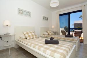 two beds in a room with a balcony at Villa Oasis in Playa Blanca +23 photos