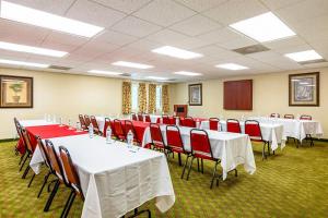 una sala de conferencias con mesas blancas y sillas rojas en Quality Inn Burkeville Hwy 360 & 460, en Burkeville