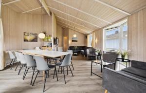 a dining room and living room with a table and chairs at Strandblick 30 in Schönhagen