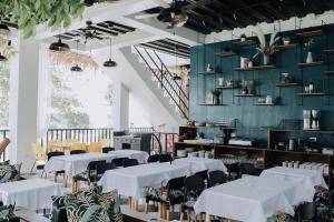 a dining room with white tables and chairs at G Boutique Resort - Santander in Santander