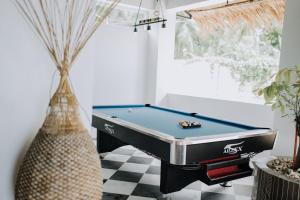 a pool table in a living room with a table at G Boutique Resort - Santander in Santander