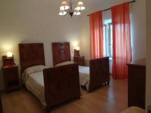 a bedroom with two beds and two night stands at La Pineta Apartment in Viareggio