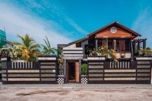 a house with a black and white exterior at Millennium in Fuvahmulah