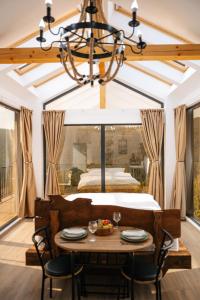 a dining room with a table and a bed at Apuseni Air - Luna in Mătişeşti