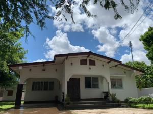 a white house with a red roof at Cozy house in Vientiane in Vientiane