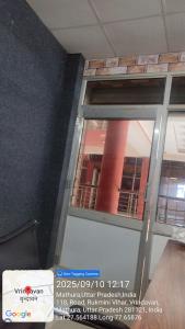 porta a vetri con finestra in camera di Hotel samarth a Vrindāvan