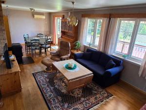 a living room with a blue couch and a table at 6 person holiday home in Osen in Vika