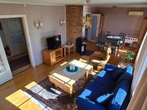 a living room with a blue couch and a table at 6 person holiday home in Osen in Vika