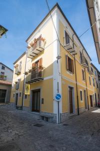żółto-biały budynek na ulicy w obiekcie Il Borgo Ospitale - Albergo Diffuso w mieście Rotonda