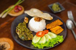 a plate of food with rice and vegetables and tofu at Terrace Garden Glamping Bogor in Gadog