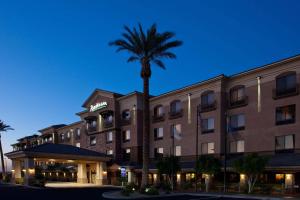 a hotel with a palm tree in front of it at Radisson Hotel Yuma in Yuma