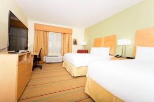 a hotel room with two beds and a flat screen tv at Radisson Hotel Yuma in Yuma
