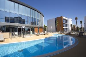 a large swimming pool in front of a building at SoBlue Hôtel in Antibes