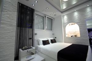 a small bedroom with a bed and a window at Monroe Apartment in Belgrade