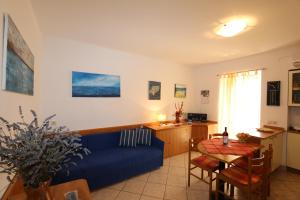 a living room with a blue couch and a table at Apartment Josip in Risika