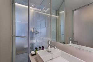 a bathroom with a sink and a mirror at Ultra Tel Aviv Boutique Hotel in Tel Aviv +46 photos