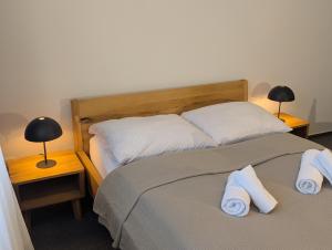 a bedroom with two beds with towels on them at Vila Matliare in Tatranská Lomnica +27 photos