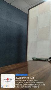 a laptop sitting on top of a wooden table at Hotel Aditya in Vrindāvan