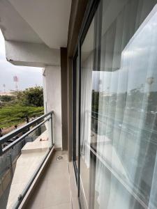a balcony with a view of the beach from a building at Cozy & Modern Studio in Nairobi West in Nairobi