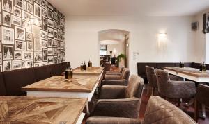 a restaurant with tables and chairs and pictures on the wall at Klosterschänke in Neukirchen beim Heiligen Blut