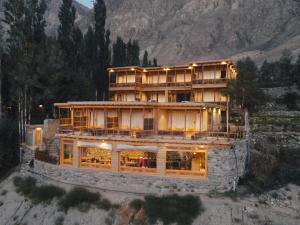 a large building on top of a mountain at Dera Lamsa Resort Shigar in Shigar