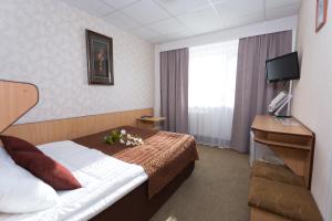 Postel nebo postele na pokoji v ubytování Toila Spa Hotel