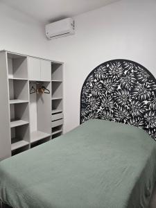 a bedroom with a bed and a black and white headboard at Villa Capucine in Saint-Paul +31 photos