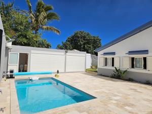 a swimming pool in the backyard of a house at Villa Capucine in Saint-Paul