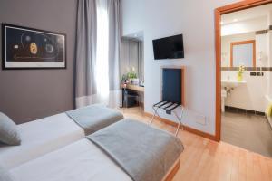 a hotel room with a bed and a television at Best Western Ars Hotel in Rome