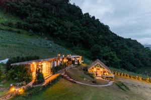 a house on a hill with lights on it at Phupetra in Ban Thung Phan Ha